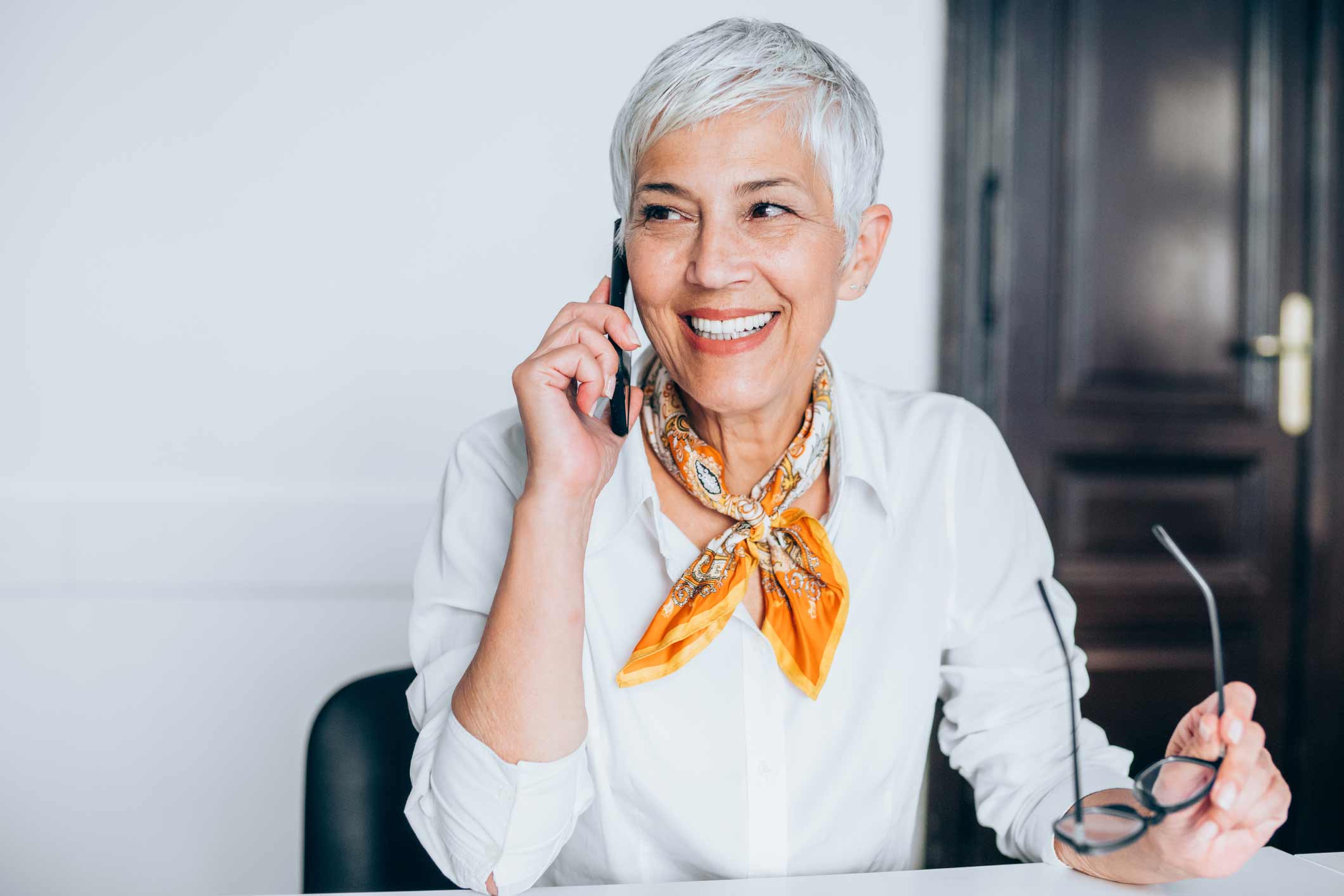 Woman talking on phone with her hearing specialist