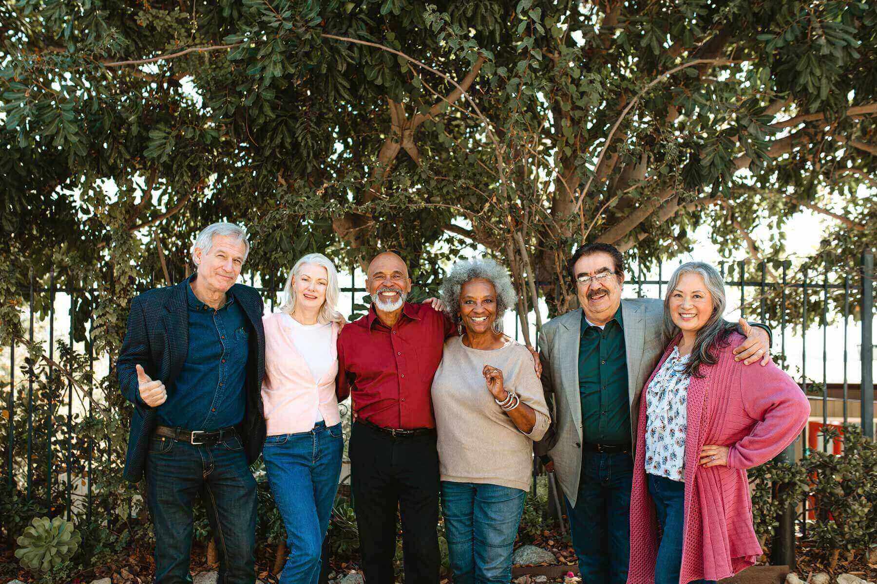 Group of adults giving a thumbs up.